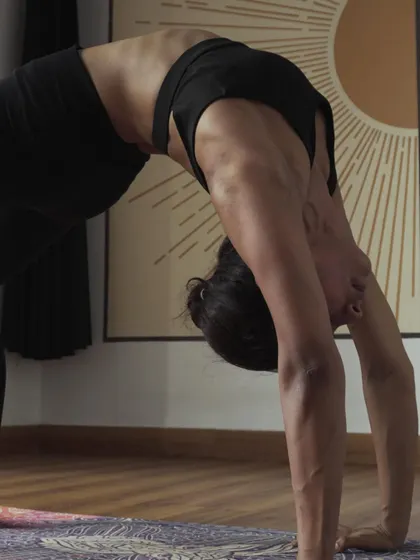 A close-up of a student in Urdhva Dhanurasana, or Wheel Pose, showcasing the strength and flexibility cultivated in our classes. This powerful backbend energizes the body and opens the heart.