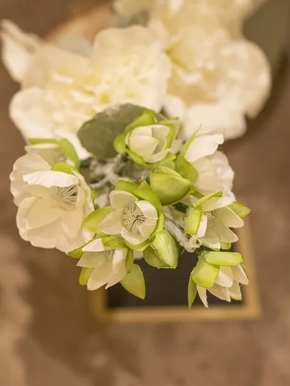 A top-down view of a delicate white bloom, showing the craftsmanship that goes into creating these everlasting flowers.