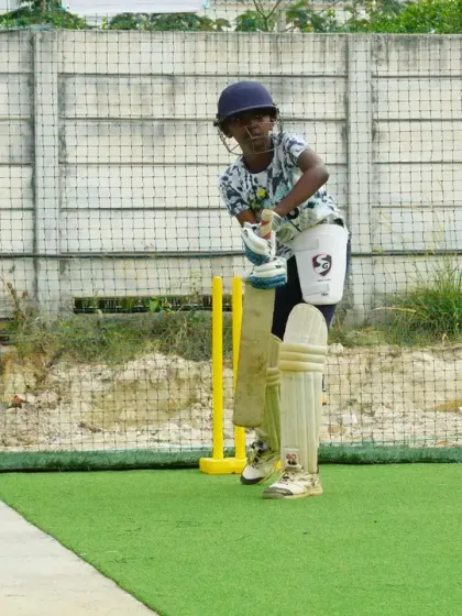 Ready for action at the crease. This young player is in his batting stance, focused and waiting for the next ball, showcasing the determination we instill in our trainees.
