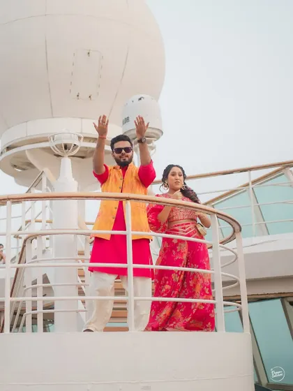 The couple enjoying the view from the top deck of the cruise ship. A grand, scenic shot that showcases the uniqueness of a wedding at sea.