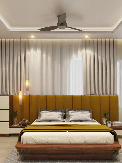 A full view of the bedroom with the mustard yellow upholstered headboard. The design is balanced with neutral side tables and soft, floor-to-ceiling curtains, creating a warm and inviting ambiance.