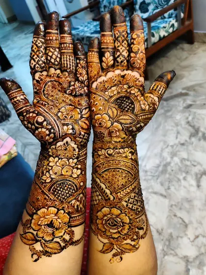 Rich, dense floral and paisley patterns cover the hands and wrists in this classic bridal style.
