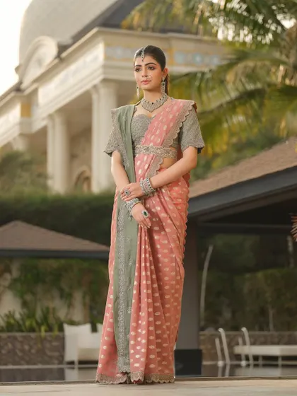 The art of draping is essential to Indian couture. For this Jayanti Reddy saree, I created a clean, pleated drape that showcases the beautiful contrast between the pink body and the sage green border, accented with a statement belt.