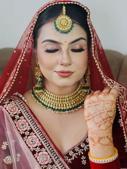Another view of the same bride, showing the flawless base and contouring that enhances her features.