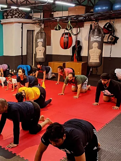 An 'animal walk' drill during a group warm-up session. This improves mobility, core strength, and gets the whole body engaged.