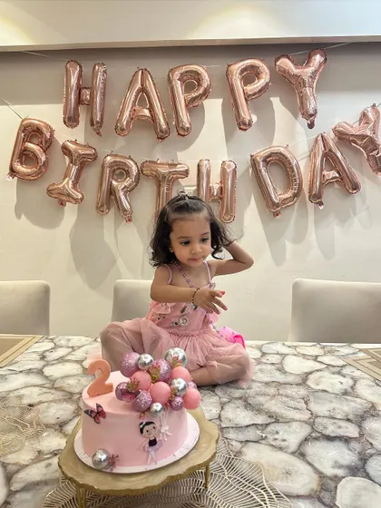 Another angle of the birthday celebration, showing how the dress moves and sits beautifully. We tailor each piece to fit perfectly, so your child is comfortable throughout their event.