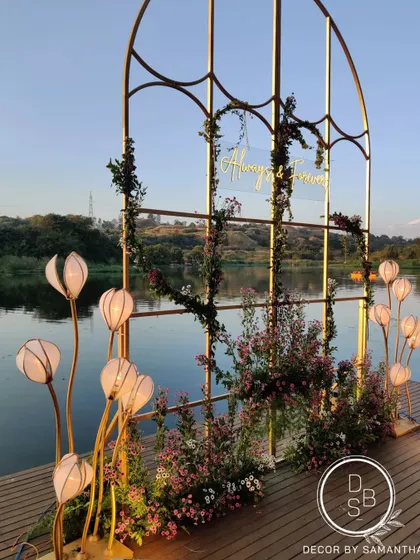 The reception backdrop set against the still waters of a natural lake at sunset. The changing colors of the sky created the most beautiful, evolving canvas for the "Always & Forever" sign.