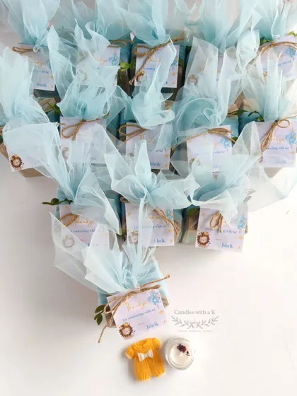 The complete order of 15 lion-themed gift boxes, elegantly wrapped in blue net, ready for Ishvik's half-birthday party.