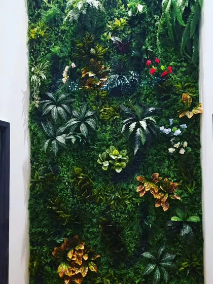 A close-up view of a mixed-foliage vertical garden. I combine different leaf shapes, colors, and sizes, including red and yellow accents, to create a vibrant and realistic plant wall.