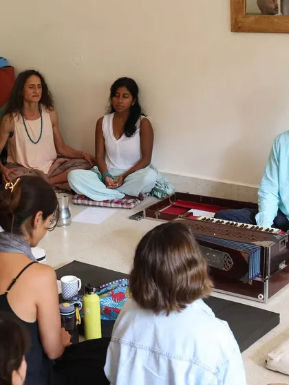 A group of seekers gathered for a chanting session with the harmonium. These moments of shared devotion are a reminder of the power of sound to connect us to the source.