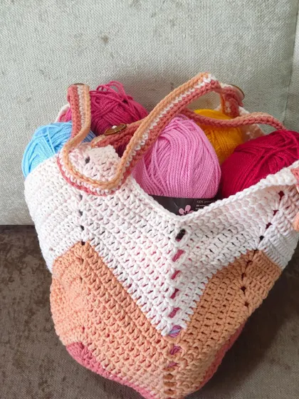 My Chevron Tulip Bag is shown here filled with colorful yarn, ready for a new project. Its roomy design makes it an ideal project bag for any crafter.