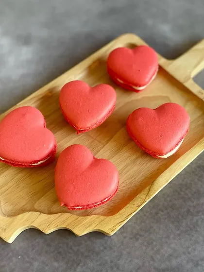Our Red Velvet Heart Macarons are a brand new addition for Valentine's Day. They have a crisp shell, a chewy center, and a creamy filling, all in a lovely heart shape.
