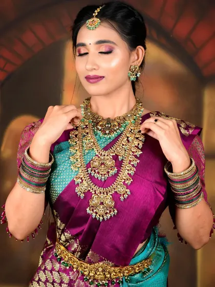 A model styled in a grand temple jewellery set, perfect for a traditional muhurtham look.
