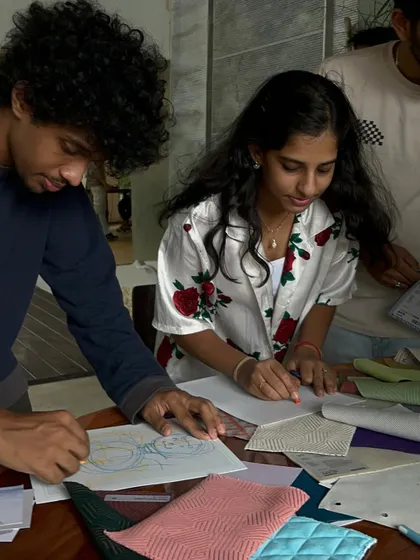Team members sketching and collaborating.