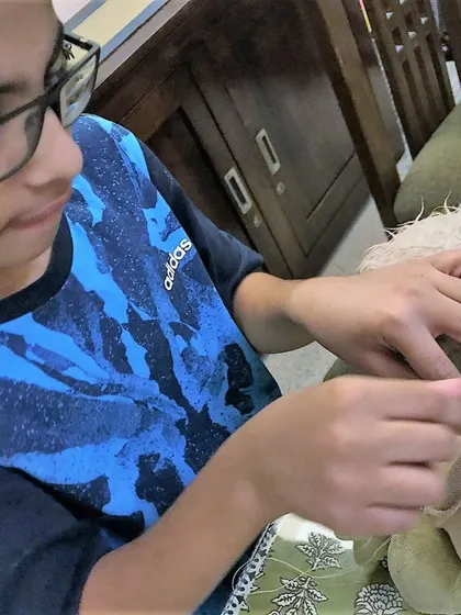 It is not just about fixing, it is about caring for the things we love. This young participant is carefully learning hand sewing techniques to mend his favorite stuffed toy, a skill that teaches patience and the value of preservation.