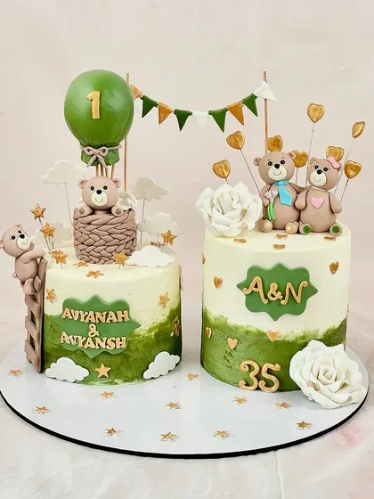 A bear-y cute celebration for Avyanah & Anyansh's first birthday and a 35th anniversary. These matching cakes feature adorable teddy bears and a lovely green and gold theme.