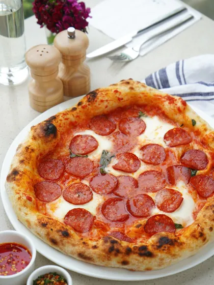 We take our Napoletana pizzas seriously. The secret lies in our special Swiss flour mix for a fluffy crust, a rich sauce from Italian San Marzano tomatoes, and locally sourced fresh mozzarella, all baked to perfection.