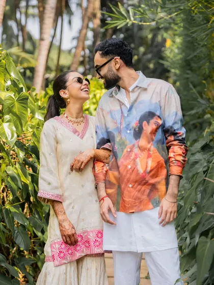 A fun and stylish shot of the couple in their casual, coordinated outfits, perfect for a relaxed destination wedding vibe.