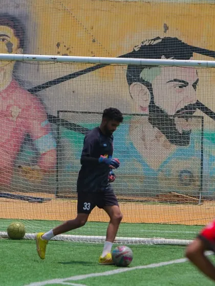 Training in an inspiring environment. A player works on dribbling drills in front of our mural of sporting legends, a constant reminder of what greatness looks like.