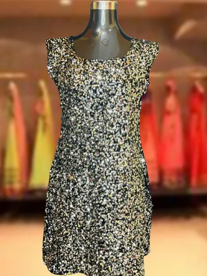 A fun and flashy short party dress covered in black and gold sequins. This sleeveless mini dress is perfect for hitting the dance floor at a birthday or New Year's Eve party.