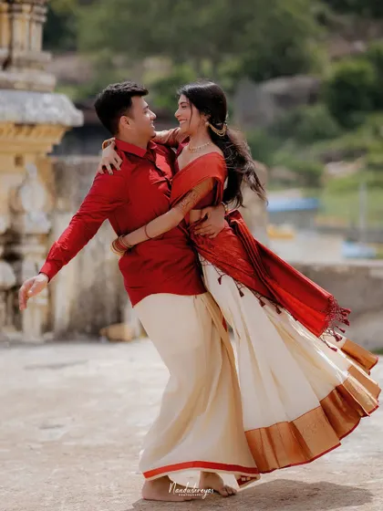 A full-body shot of the couple dancing, capturing the movement of the bride's traditional skirt.