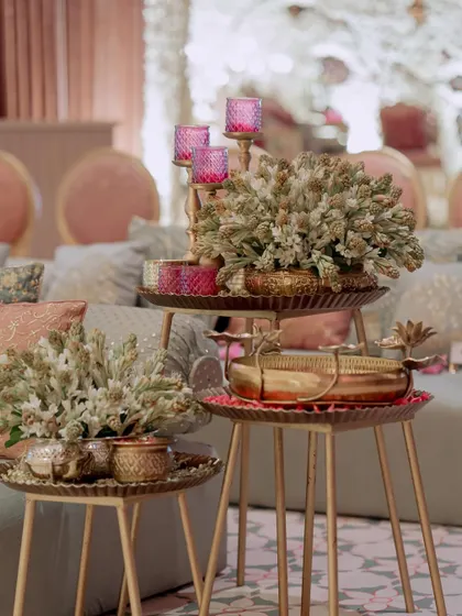 A close-up of the side table decor, showing how we layer different elements like floral arrangements, candles, and brass trays to create visually interesting compositions.