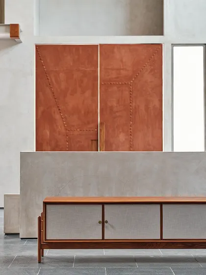 A subtle, earthy-colored door demonstrates fine craftsmanship with its stitched detail. This element adds a sense of depth, dimension, and bespoke quality to the overall design of the space.