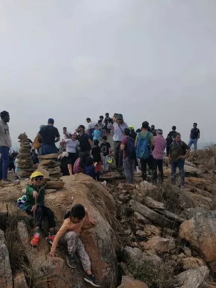 The entire community gathers at the peak during our trek, sharing snacks and enjoying the view together.