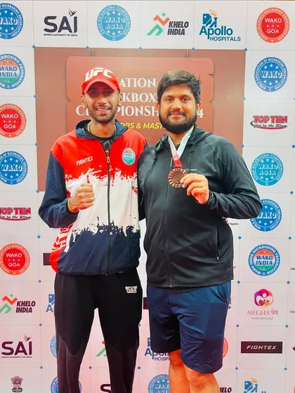 As a coach, I also compete. Here I am with my bronze medal at the WAKO National Kickboxing Championship for masters. I lead by example.