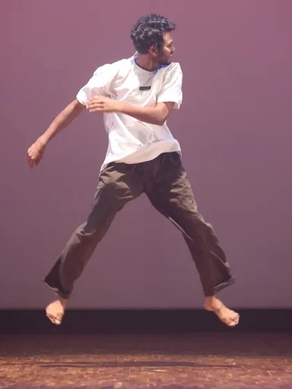 An open-style dancer caught mid-jump, showcasing the energy and freedom of our freestyle and hip-hop classes.