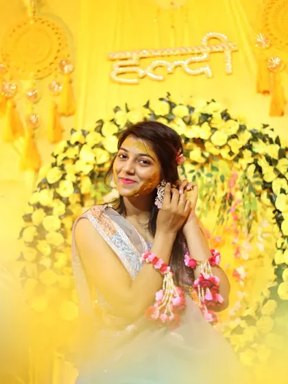 A beautiful portrait of the bride-to-be during her Haldi. The soft, warm lighting and her gentle pose create a timeless image amidst the vibrant celebration.