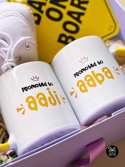 A close-up of the "Promoted to Aaji" and "Promoted to Aaba" mugs, a favorite choice for sharing the exciting news with Maharashtrian families.