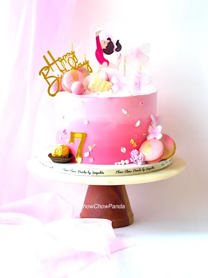 A side view of the gymnast cake, highlighting the number 7 and Ferrero Rocher accent.