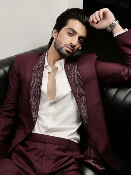 A relaxed pose in our maroon tuxedo with embroidered lapels. The open collar look gives it a modern, effortless vibe, perfect for a stylish cocktail party or reception.