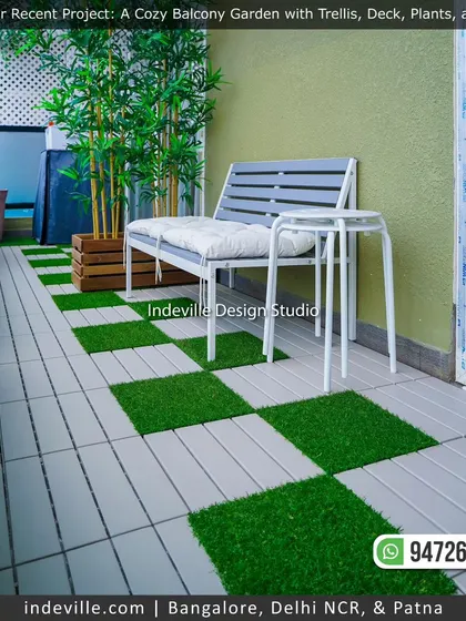 A clean and modern balcony design. I used a combination of light-colored deck tiles and artificial grass in a checkerboard pattern, paired with a simple bench and bamboo plants, to create a fresh and inviting space.