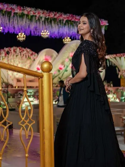 A sophisticated reception look in a classic black gown. The makeup is timeless and elegant, with a focus on flawless skin and defined eyes.