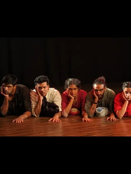 The performers of 'Sea's Fire' in a moment of shared exhaustion and despair, powerfully conveying the emotional weight of the story.