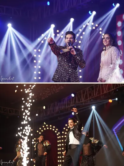 The groom's energetic performance on stage, with dramatic spotlights creating a concert-like atmosphere.