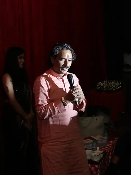 A senior member of our faculty addresses the audience during the annual function. We honor the tradition of the Guru-Shishya parampara, where our experienced gurus share their wisdom.