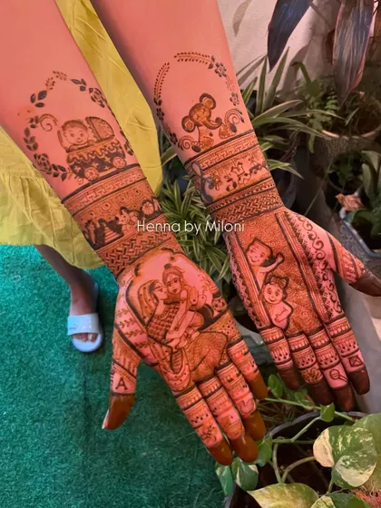 The full view of a heartwarming baby shower mehendi. The design tells a story with portraits of the couple, their baby, and other sweet details.