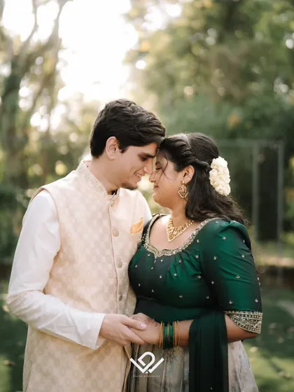 An intimate close-up of a couple during their engagement shoot, dressed in elegant traditional wear.