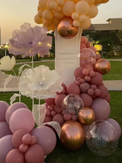 A close-up of the balloon and paper flower installation, highlighting the different sizes and textures that create a rich, dynamic look.