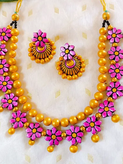 These are additional images of the floral necklace sets in various colors, showcasing the wide range of options available for bulk purchase.