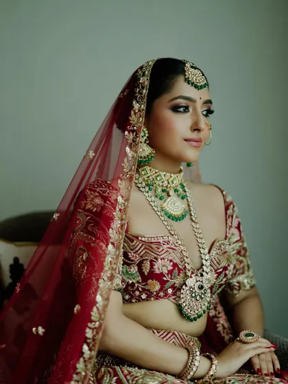 For this bride, we balanced enchanting kohl-rimmed eyes with a soft, captivating lip color. Her look is a perfect example of how to blend traditional elements with modern bridal beauty.