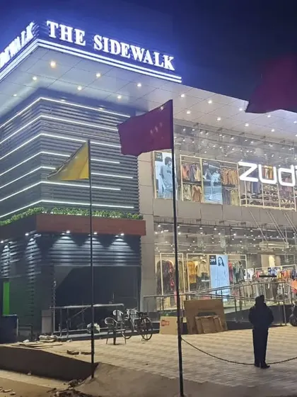 The completed commercial building at night, fully operational and lit up.