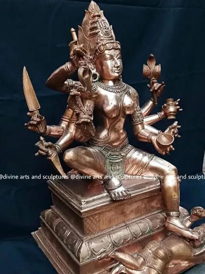 A bronze statue of Mysore Chamundeshwari, a form of Durga. The sculpture depicts her slaying the demon Mahishasura, a powerful symbol of the victory of good over evil.