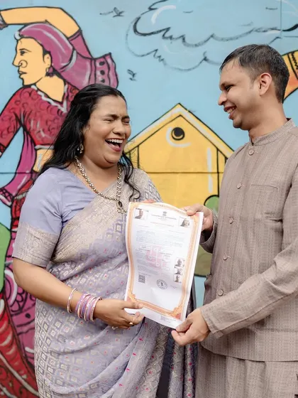 The official moment! The couple joyfully holds up their marriage certificate, a perfect blend of officialdom and celebration.