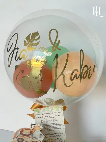 A personalized balloon for Jia and Kabir's 3rd birthday. The safari theme is carried through with a Simba graphic and jungle leaf details, showing how I can tailor every element to a specific party theme.