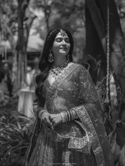 A beautiful black and white candid of the bride, lost in a happy thought. The soft light and her serene expression create a timeless and artistic portrait.