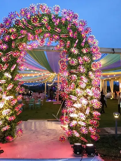 Welcome to the Sangeet! We crafted this playful entrance arch using hundreds of colorful Indian pinwheels that spun in the breeze, creating a festive and whimsical entry point for a night of fun.